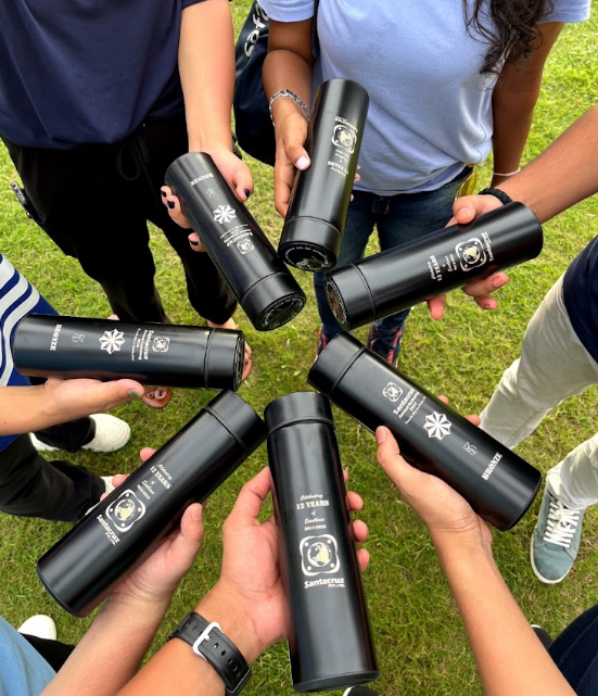 SantaCruz team holding commemorative 12 Years of Excellence bottles during the outing